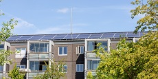 Residential building with new roof and solar panels. Real Estate investment. Expensive housing.